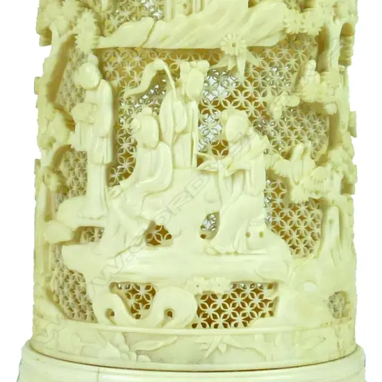 A good late 19thC Chinese finely carved ivory tusk section brush pot carved in relief with figures in a landscape of trees