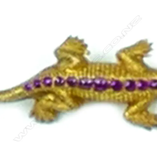 An early 20thC 18ct. gilded yellow gold ruby and diamond lizard form brooch