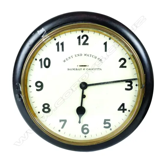 An old wood-cased school clock with brass bezel and Arabic numerals. Diameter 370. West End Watch Co.