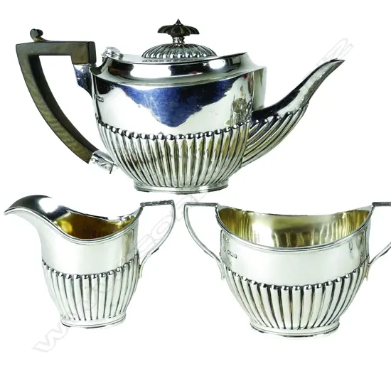 A silver Georgian Revival three-piece bachelor's tea set