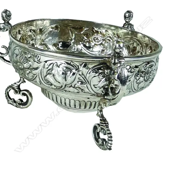 A silver bowl raised on three caryatid legs