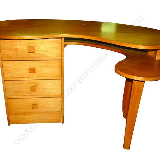 A mid-20thC exotic pale timber kidney form desk