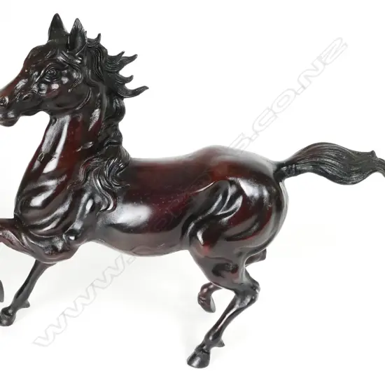 A cast steel statuette of a galloping horse