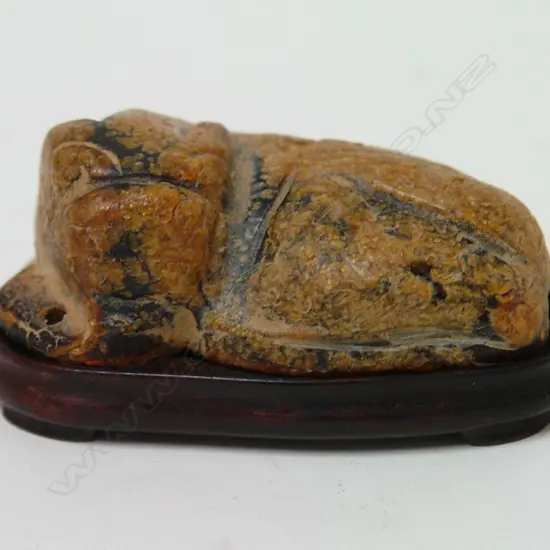 An old Chinese gilded amber carving of a shishi