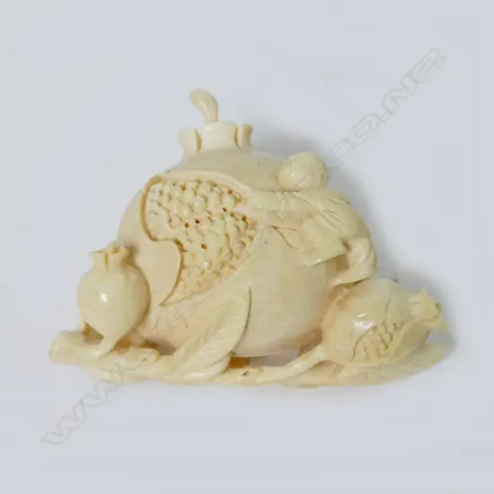 An ivory snuff bottle modelled as a giant pomegranate