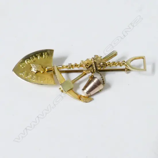 A 15ct. gold and gold nugget miner's brooch