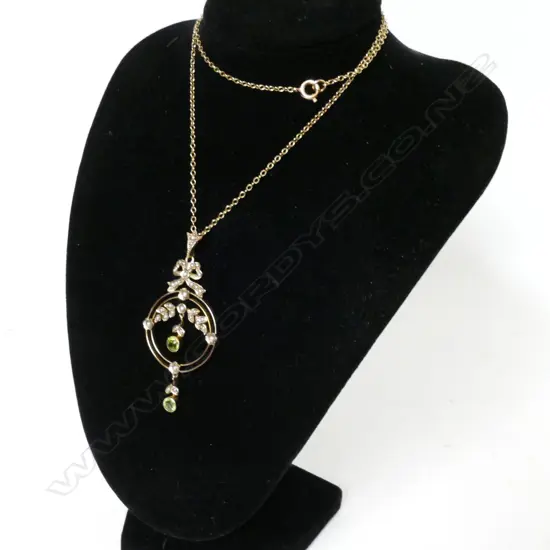 An Edwardian 9ct. gold peridot and seed pearl pendant