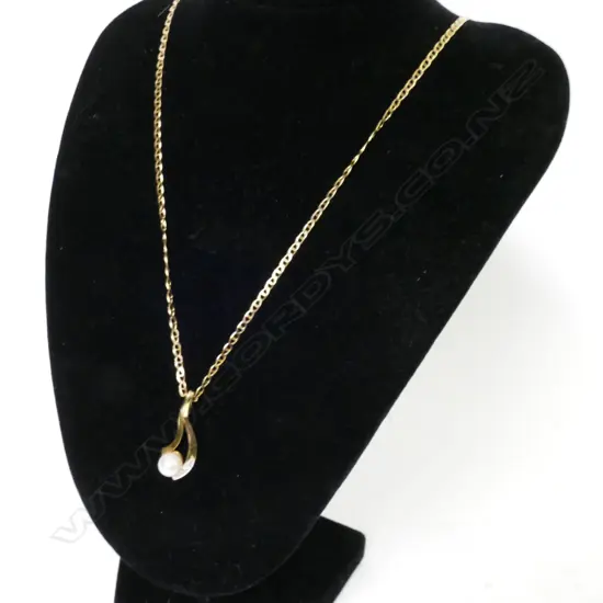 An 18ct. gold pearl and diamond pendant