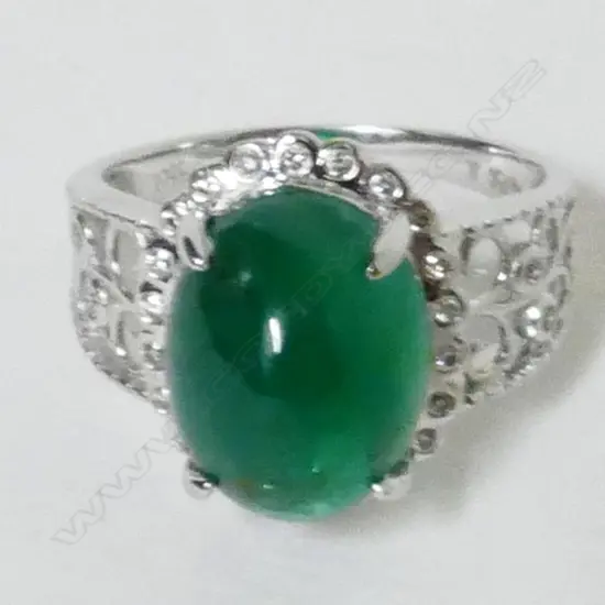 An 18ct. white gold emerald and diamond ladies dress ring