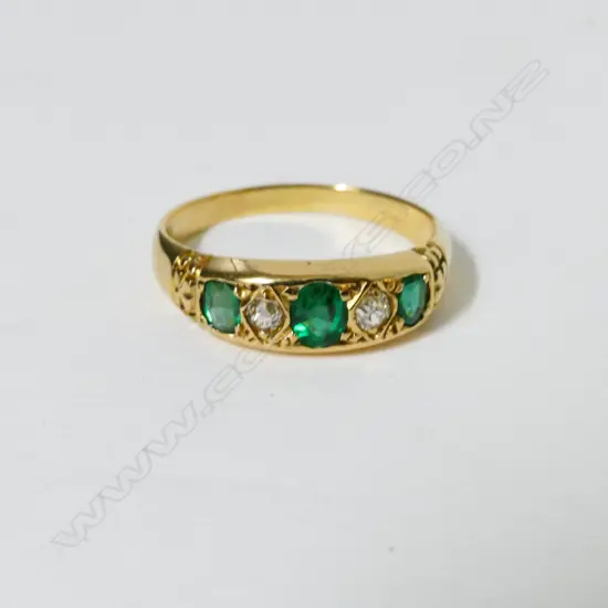 An 18ct. gold emerald and diamond ring