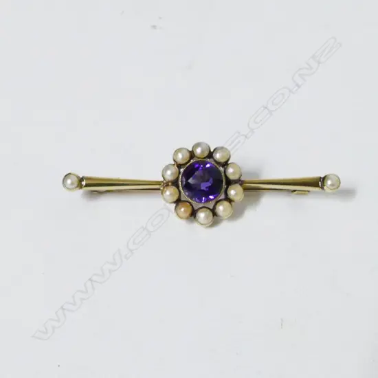 An antique 15ct. gold amethyst and pearl bar brooch