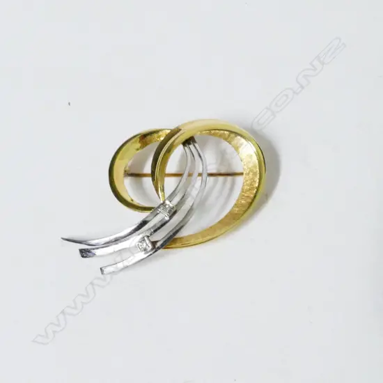 A retro 14ct. gold and diamond brooch