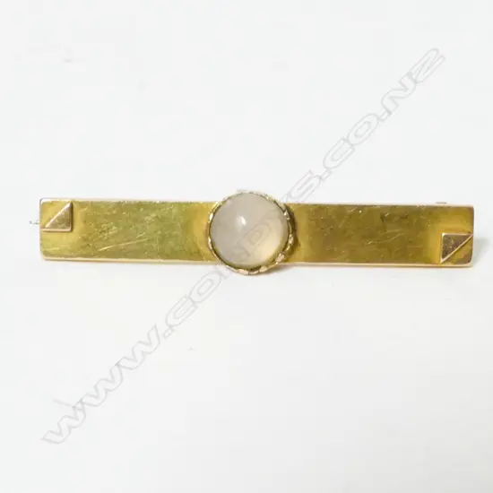 A Colonial 15ct. gold and moonstone bar brooch