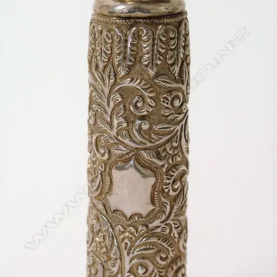 An early 20thC silver embossed tall cylindrical scent bottle