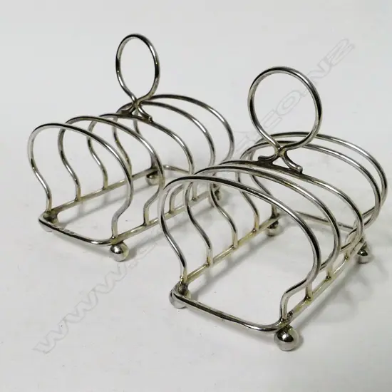 A pair of small silver toast racks