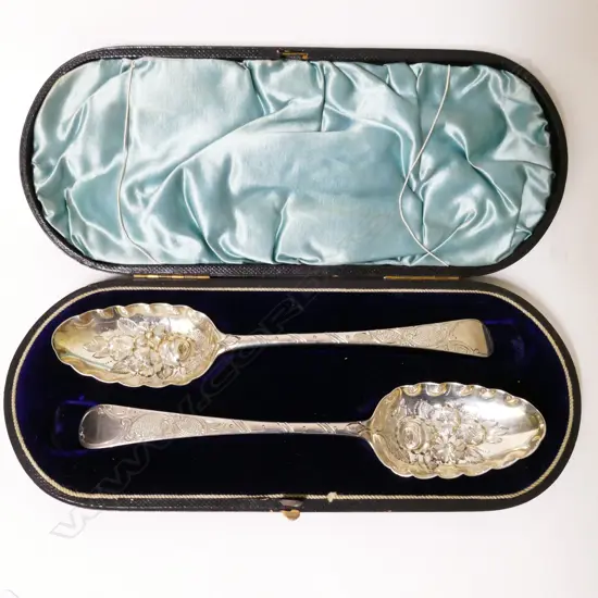 A cased pair of silver bottom marked berry spoons
