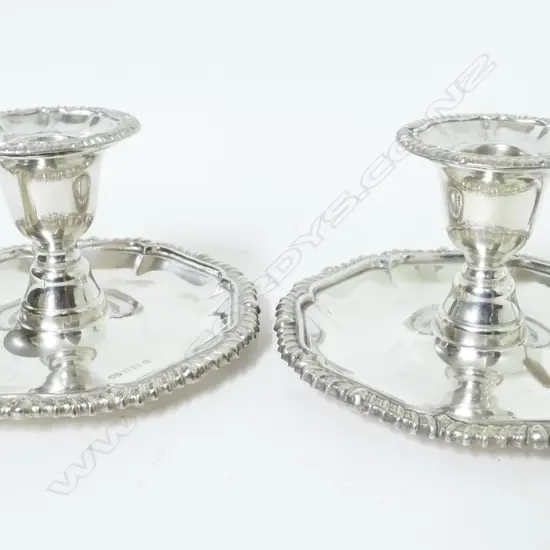 A pair of Georgian style chamber sticks with snuffers