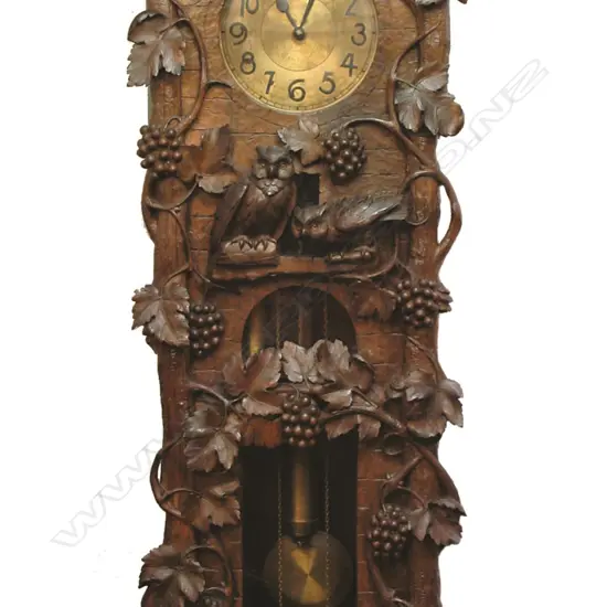 A spectacular walnut carved Black Forest long case clock