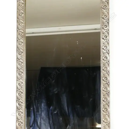 A highly decorative metal framed mirror