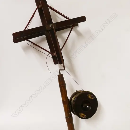 A wooden line winder with copper and brass fittings