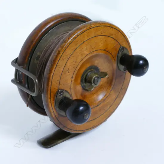 A 4" walnut and brass reel