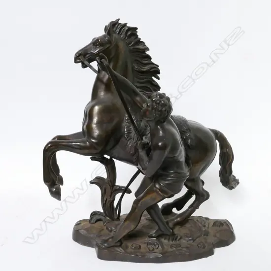 A replica bronze statuette of a Marly horse and trainer