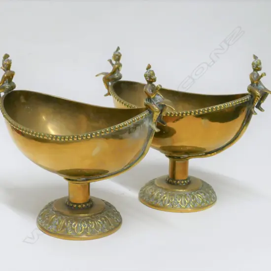 A pair of Indian brass dishes on pedestal bases