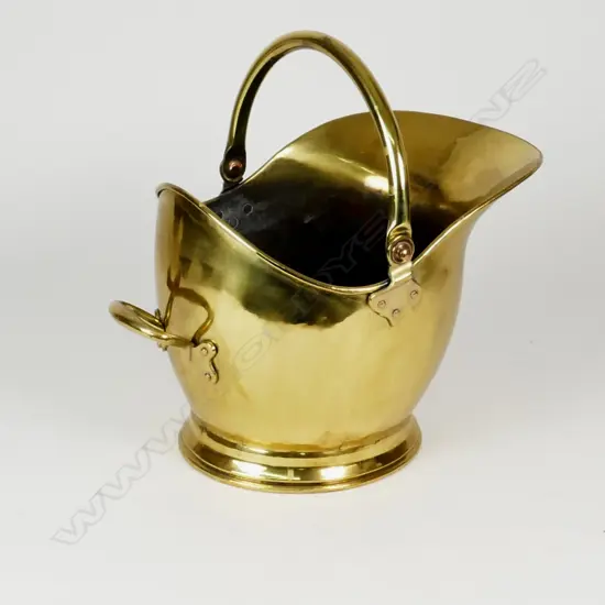 A 19thC brass helmet coal scuttle