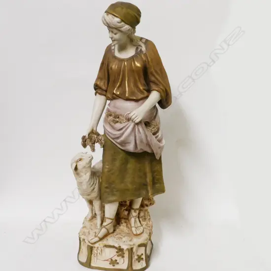 A Royal Dux bone china figure of a woman with sheep