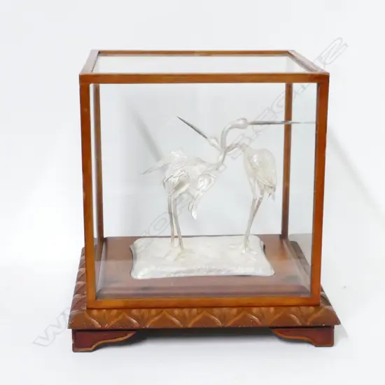 a pair of silver cranes