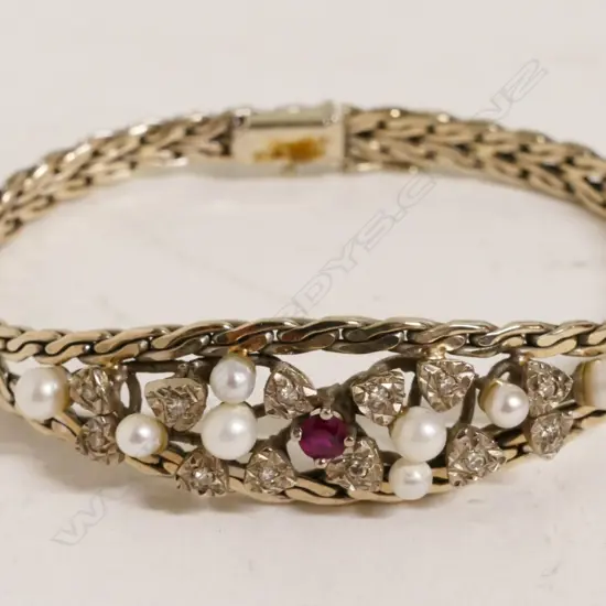 A 14ct. white gold pearl diamond and ruby bracelet