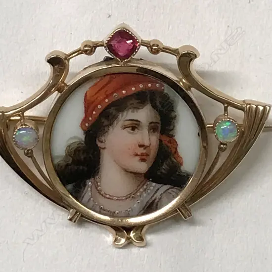 A 14ct. rose gold gem set picture brooch