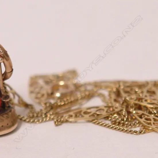 A 19thC gold cricket themed fob seal on a 14ct. yellow gold chain