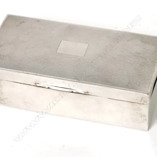 A silver cigarette box of oblong shape with engine turned lid