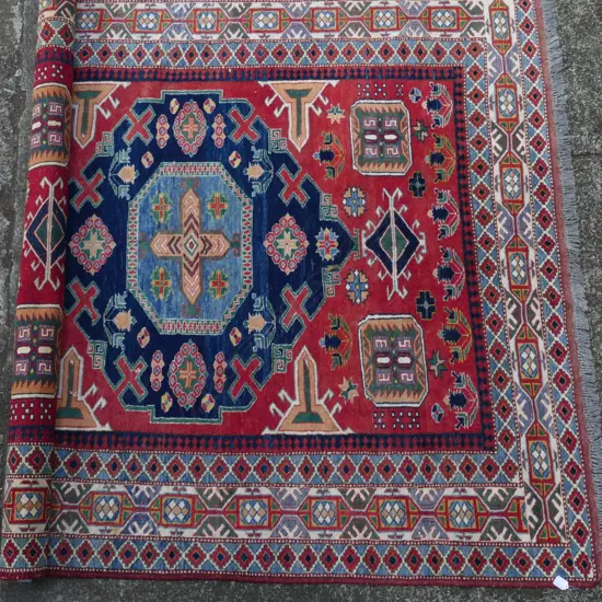 A hand knotted Kazak rug