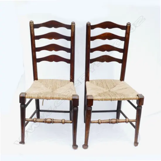 A set of four English oak country ladderback dining chairs