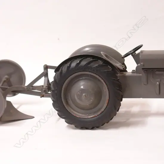 An old Massey Ferguson TE-20 die-cast toy tractor with plough