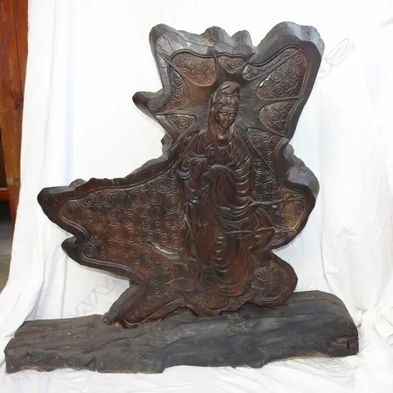 A Japanese slab trunk section carved with Kwannon