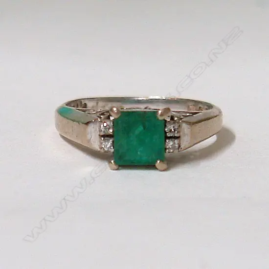 A 1940s 14ct. white gold emerald and diamond dress ring