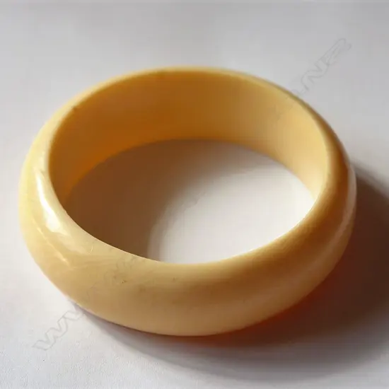 A substantial carved ivory bangle