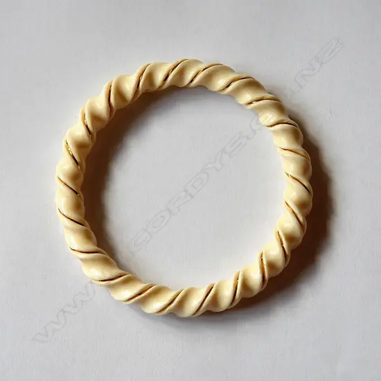 A spiral carved ivory bangle with gold wire highlight