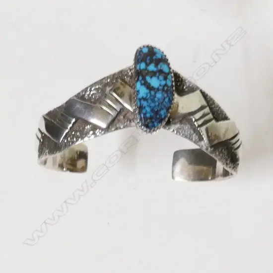 A silver Navajo cuff bangle