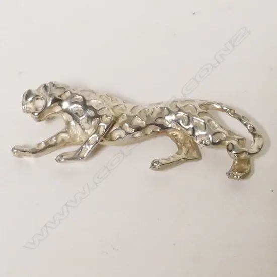 A silver brooch in the form of a jaguar