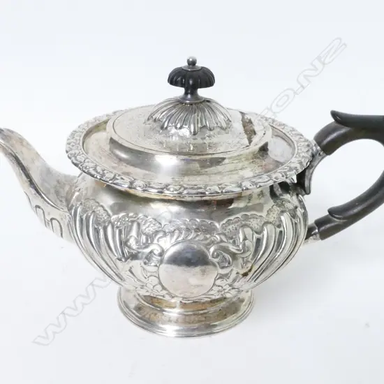 A small decorative Victorian silver teapot