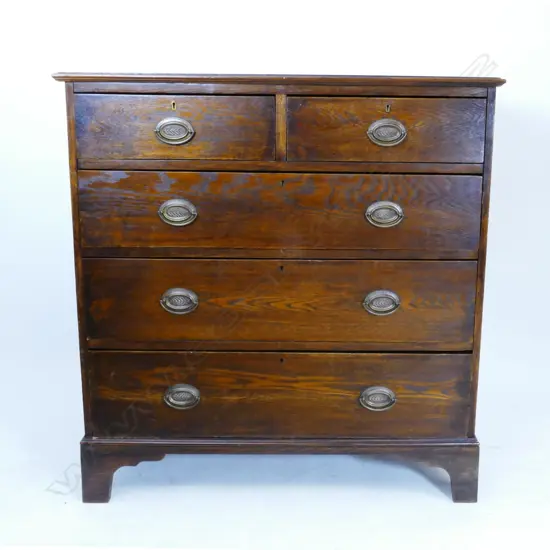 An oak five drawer flat-front chest