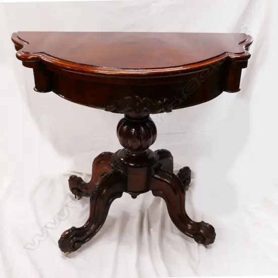 A Victorian walnut serpentine demi-lune fold-over card table