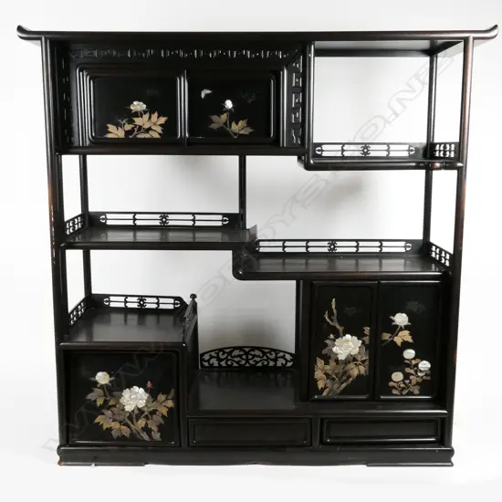 An old Chinese ebonised display cabinet with tiered galleried open shelves